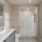 Dog-Friendly Luxury Apartments in Alexandria, VA - Aventon Huntington Station - Bathroom with a Double Vanity, a Glass Frameless Shower, and a Light-Up Mirror