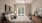 Pet Friendly Luxury Apartments in Alexandria VA- Aventon Huntington Station - Bedroom with Ceiling Fan, Bed, Two End Tables, Chair, Round Mirror, and Large Window