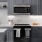 Luxury Apartments in Alexandria VA with In Unit Washer and Dryer - Aventon Huntington Station - Kitchen with Charcoal Gray Shaker Cabinets and Undercabinet Lighting, White Quartz Countertops with Herringbone Tile Backsplash, and Glass Stove Cooktop